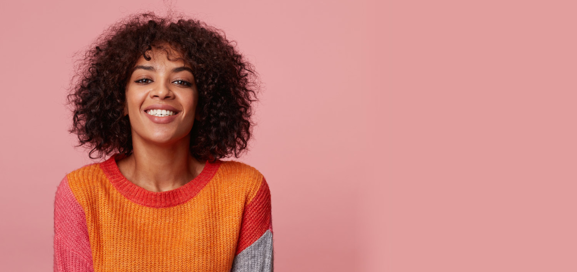 Positive Optimistic Charming Girl Looking Confident Joyful Afro Hairstyle Smile Wearing Colorful Longsleeve Pink Background